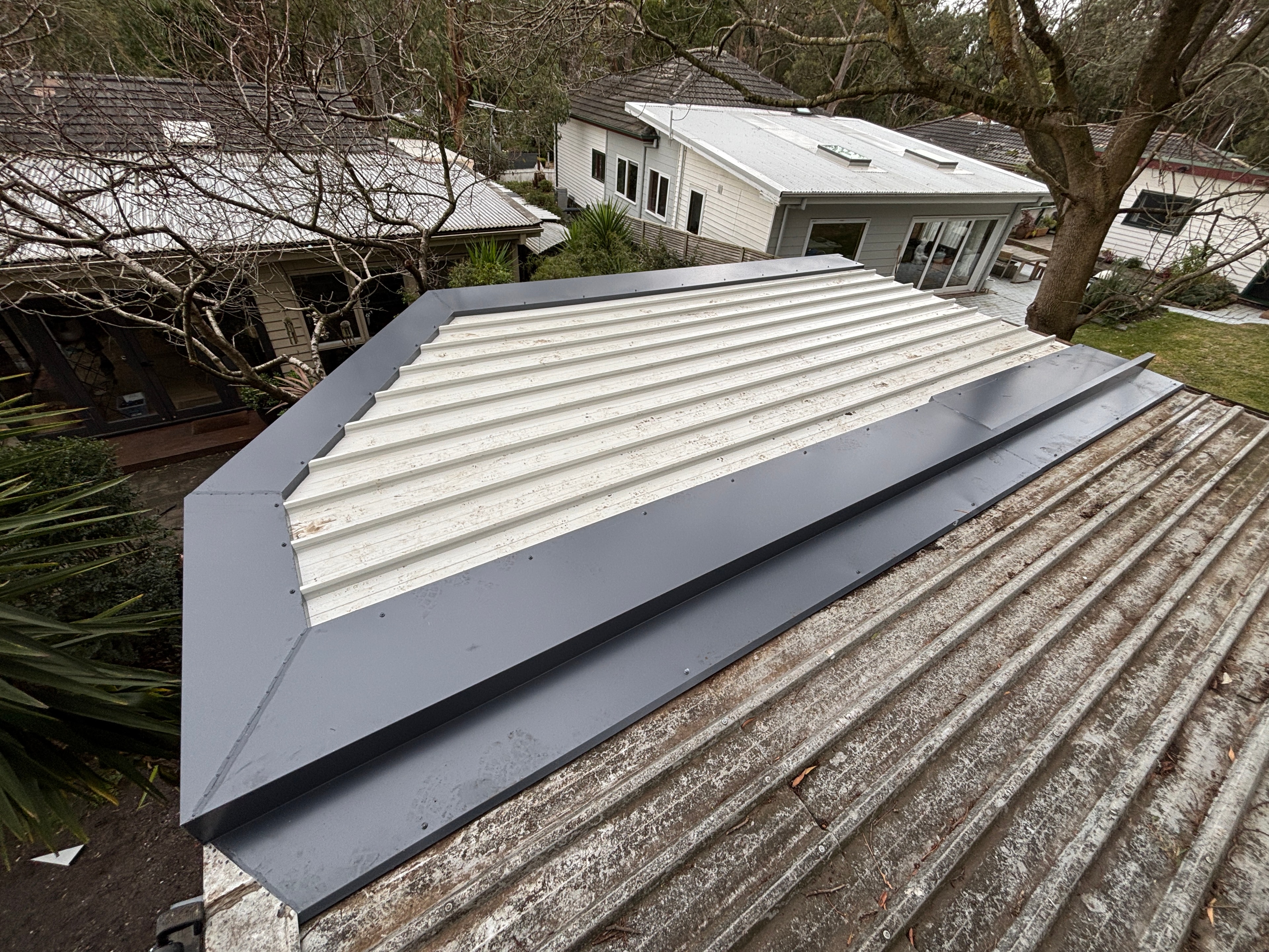 White corrugated cladding with garden and tropical plants